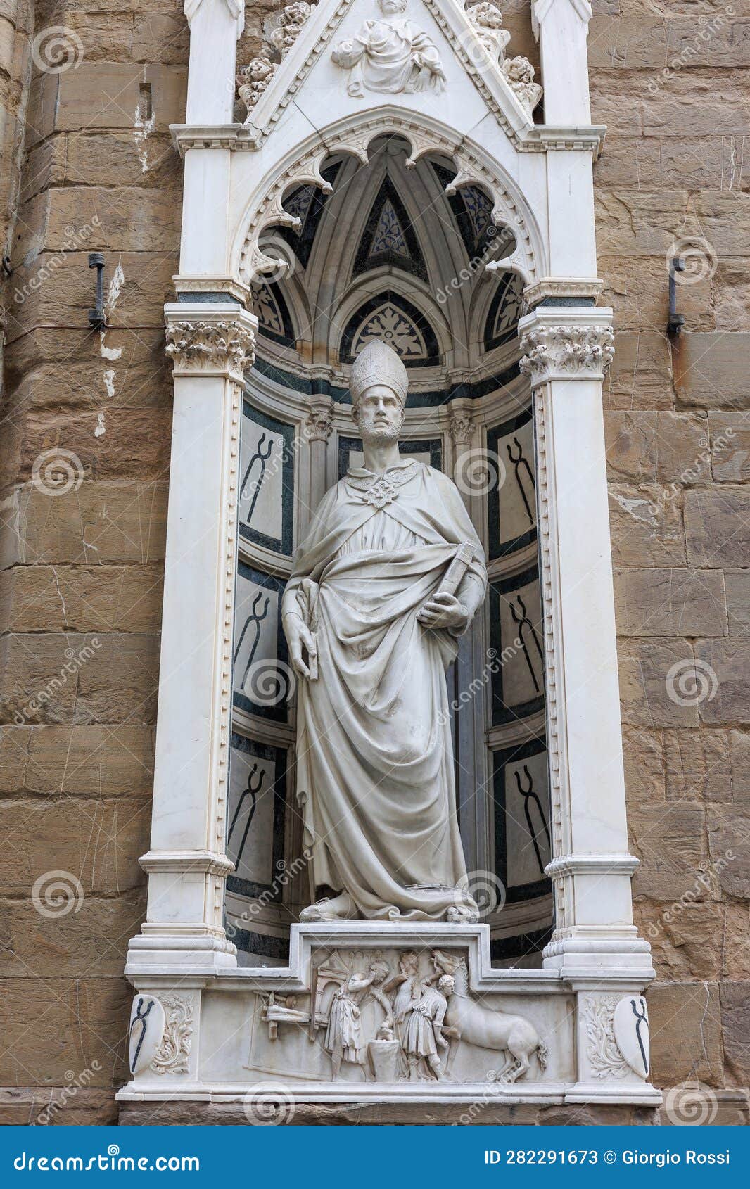 statue of saint eligius in the tabernacle in the exterior perimeter of the church of orsanmichele in florence, italy