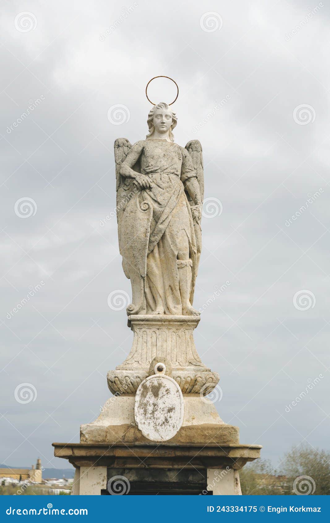 statue of saint raphael in the middle of the roman bridge in cordoba, spain