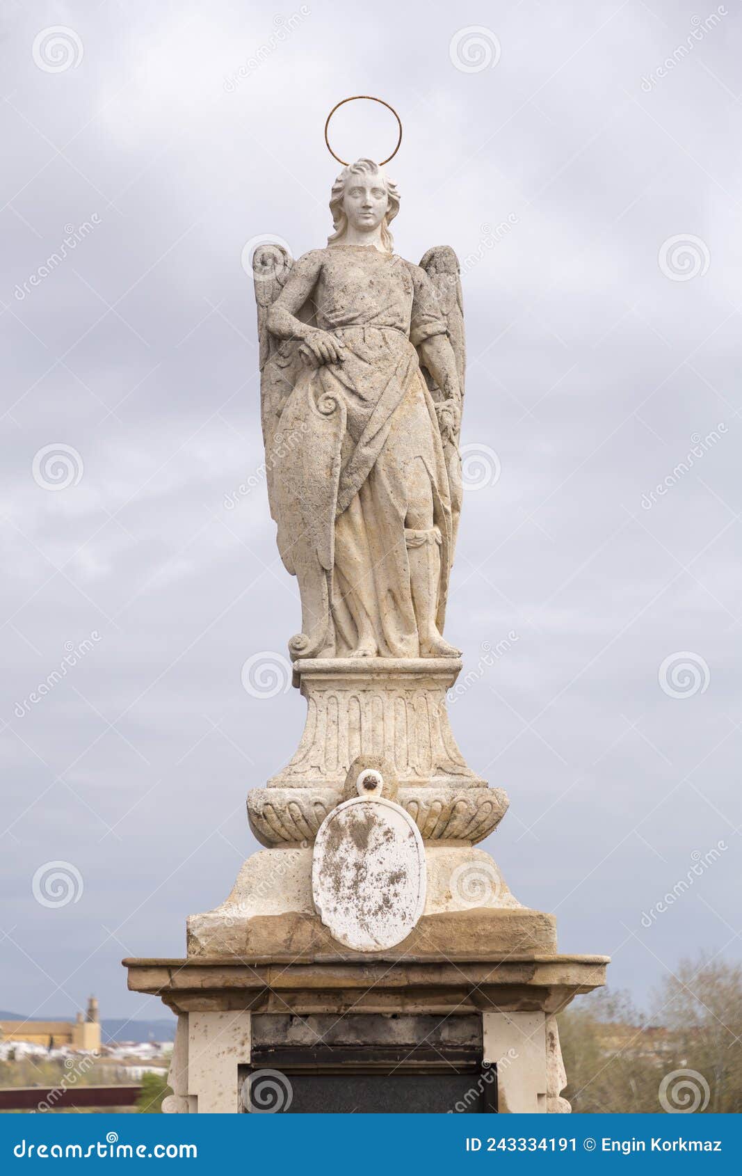 statue of saint raphael in the middle of the roman bridge in cordoba, spain