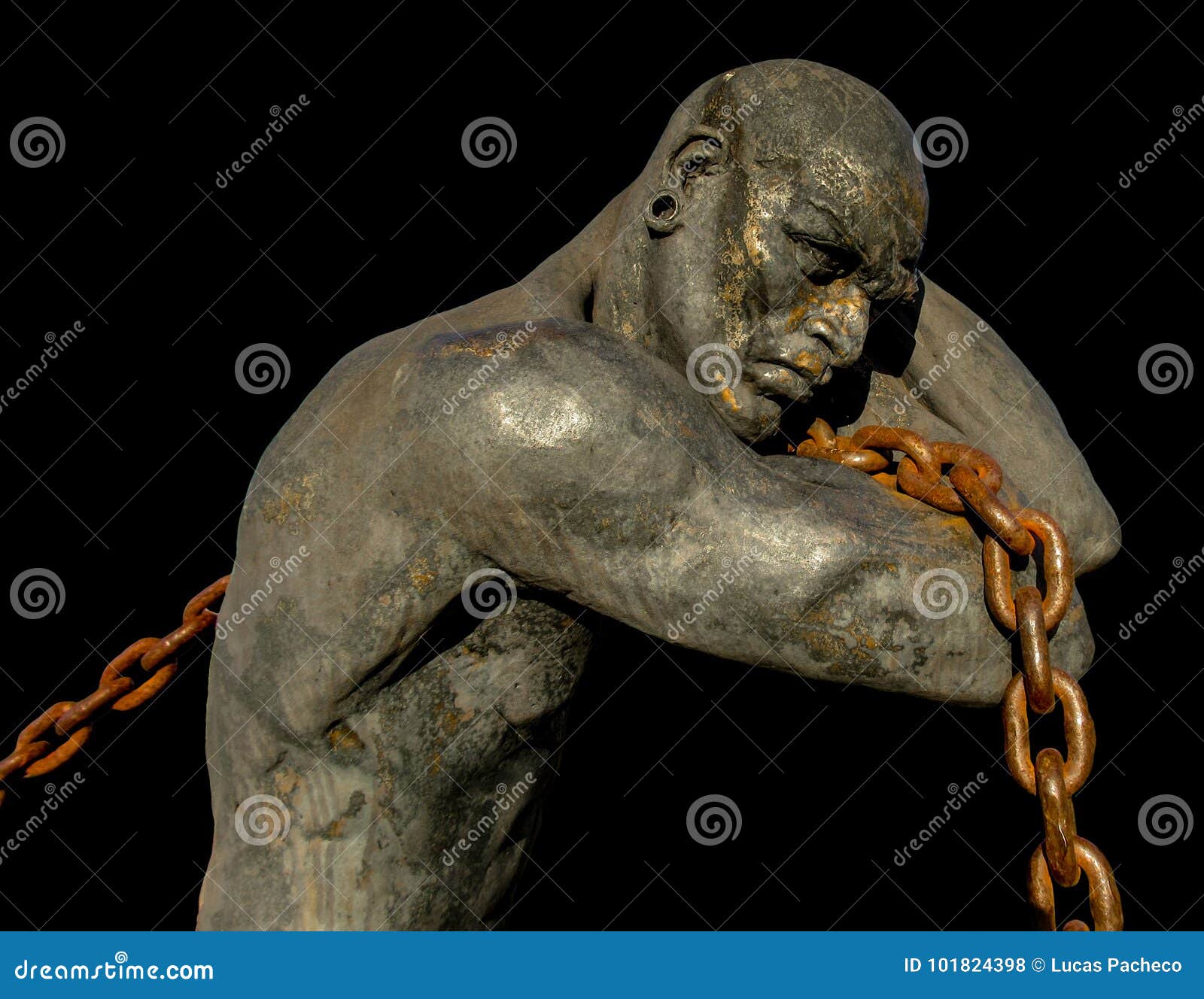 statue of a slave carrying a boat using a chain