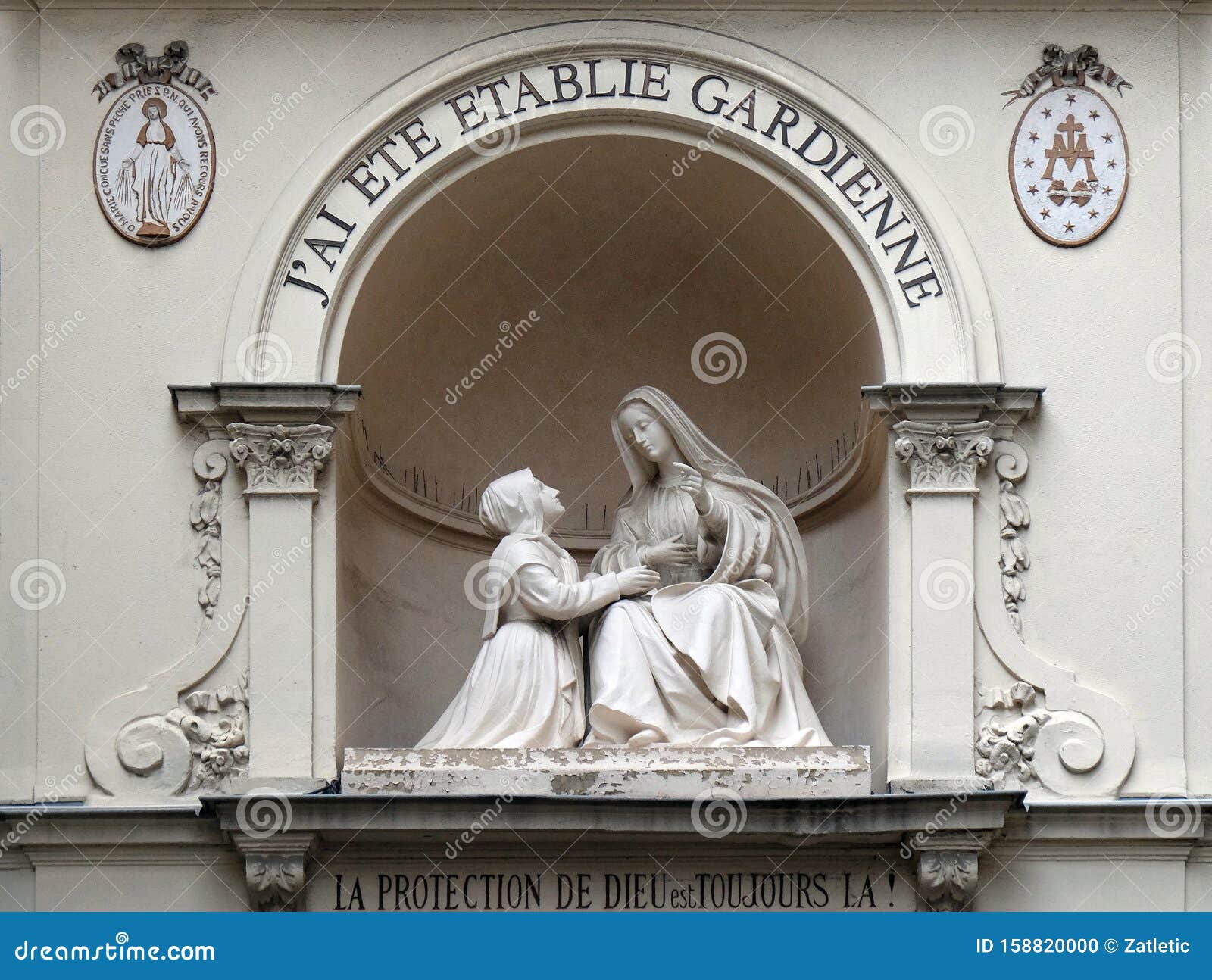 statue of st catherine and the virgin mary outside the chapelle notre dame de la medaille miraculeuse in paris