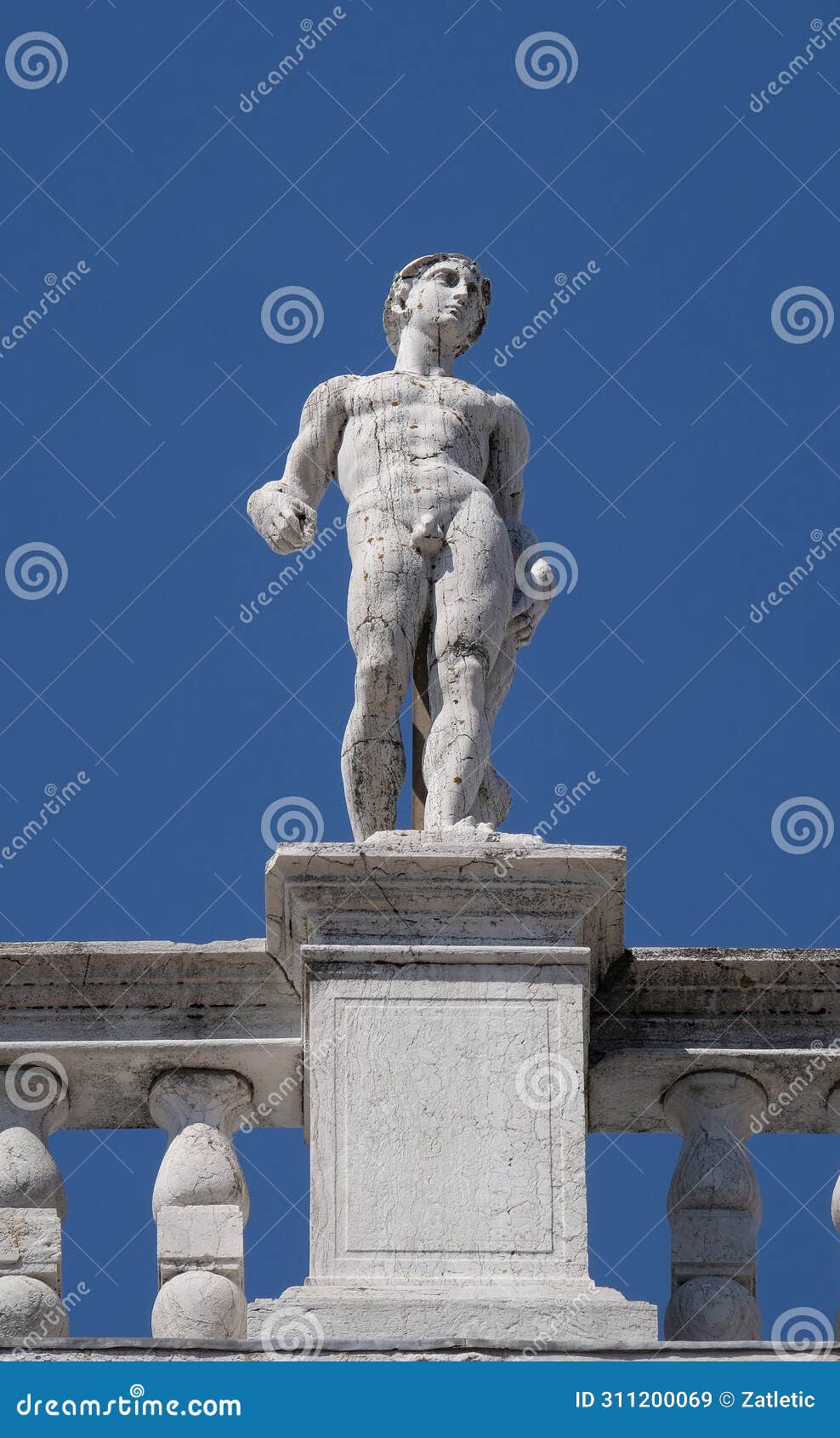 statue at the top of national library of st mark`s biblioteca marciana, venice