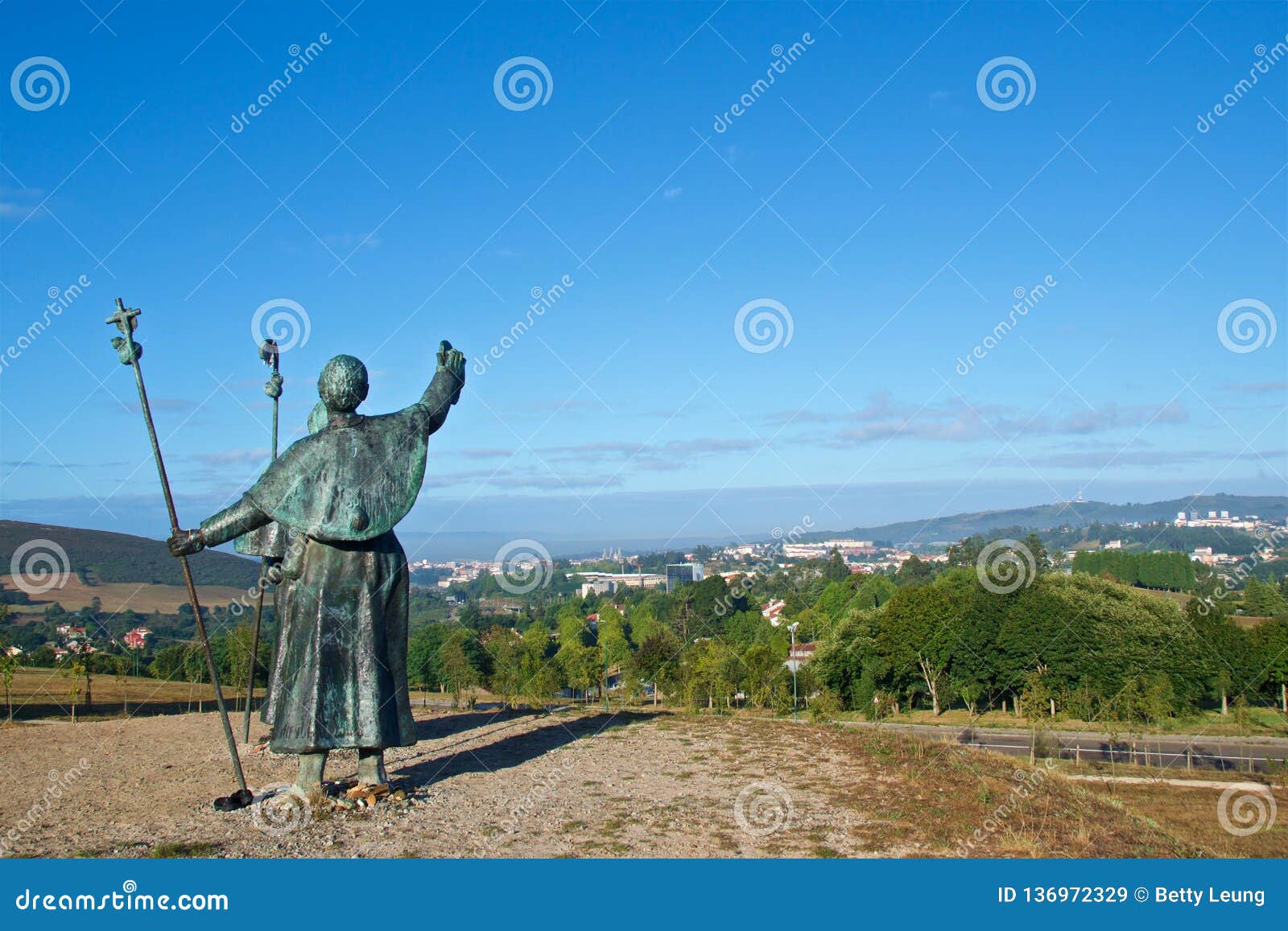 statues of pilgrims pointing the cathedral on monte do gozo in santiago de compostela, spain