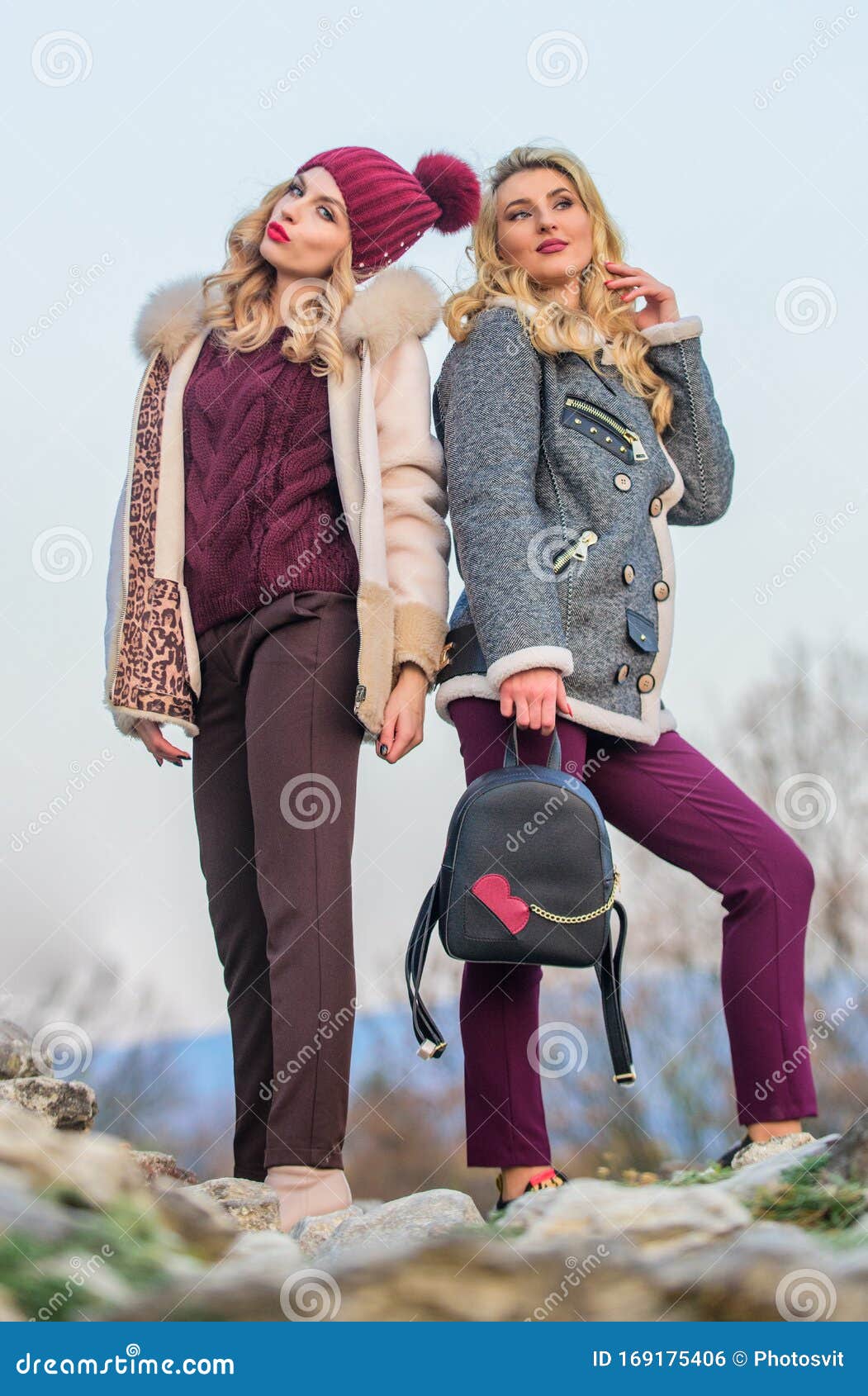 Stay warm and fashionable. Women wear furry coats. Winter clothes. Wardrobe  for cold weather. Girls enjoy cozy fancy chic coats. Natural wool sheepskin  coats. Fur shop. Backpack fashion accessory Stock Photo 