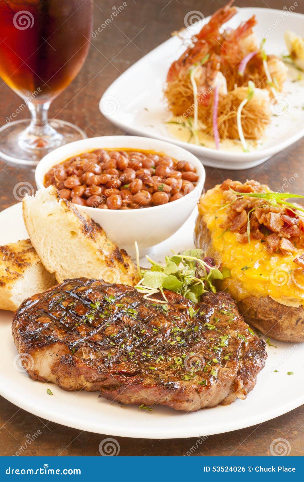 Steak with Baked Potato, Beans and Garlic Bread Stock Photo - Image of ...