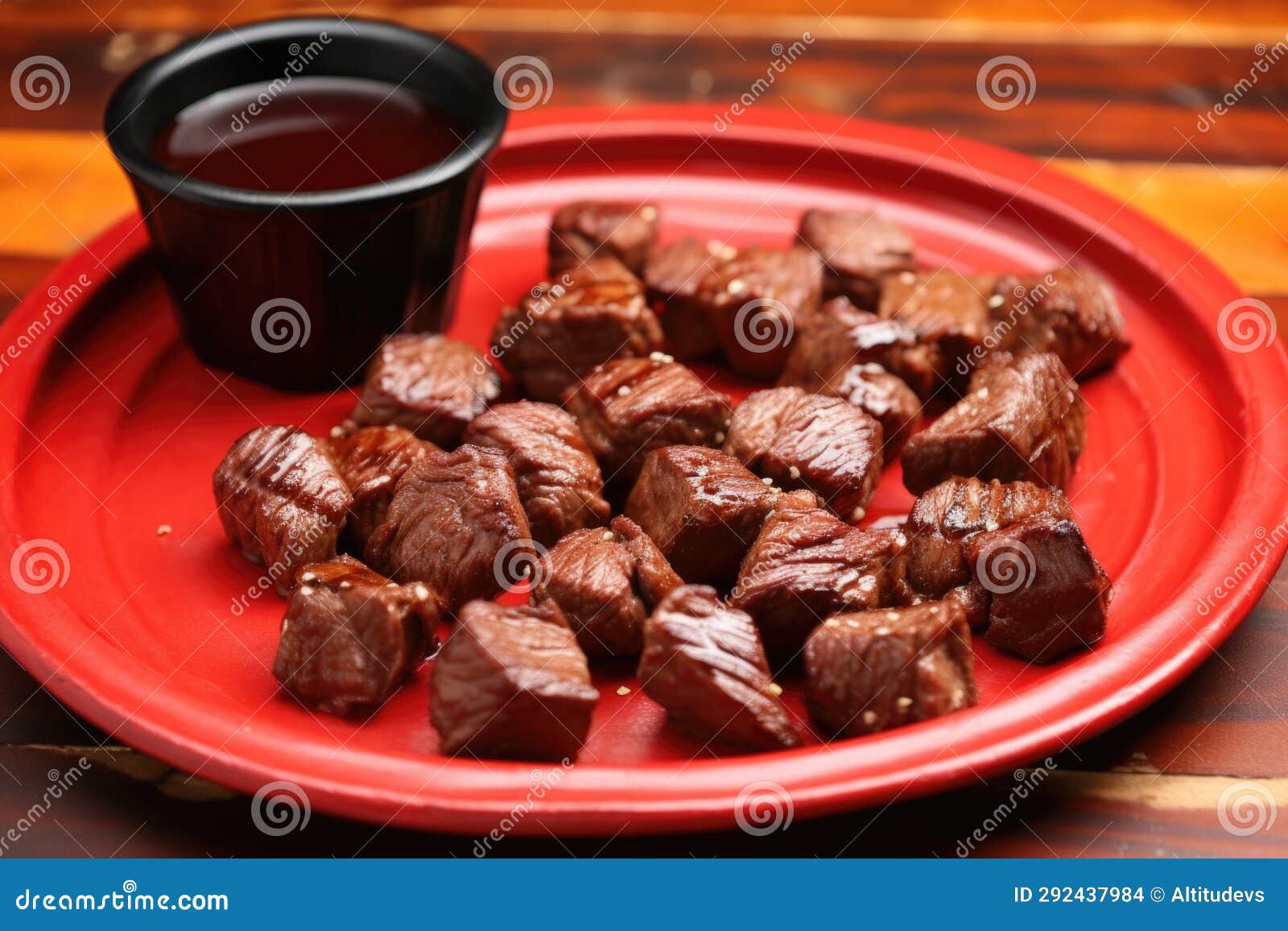 Steak Tips with Garlic and Bbq Sauce on a Red Ceramic Plate Stock Photo