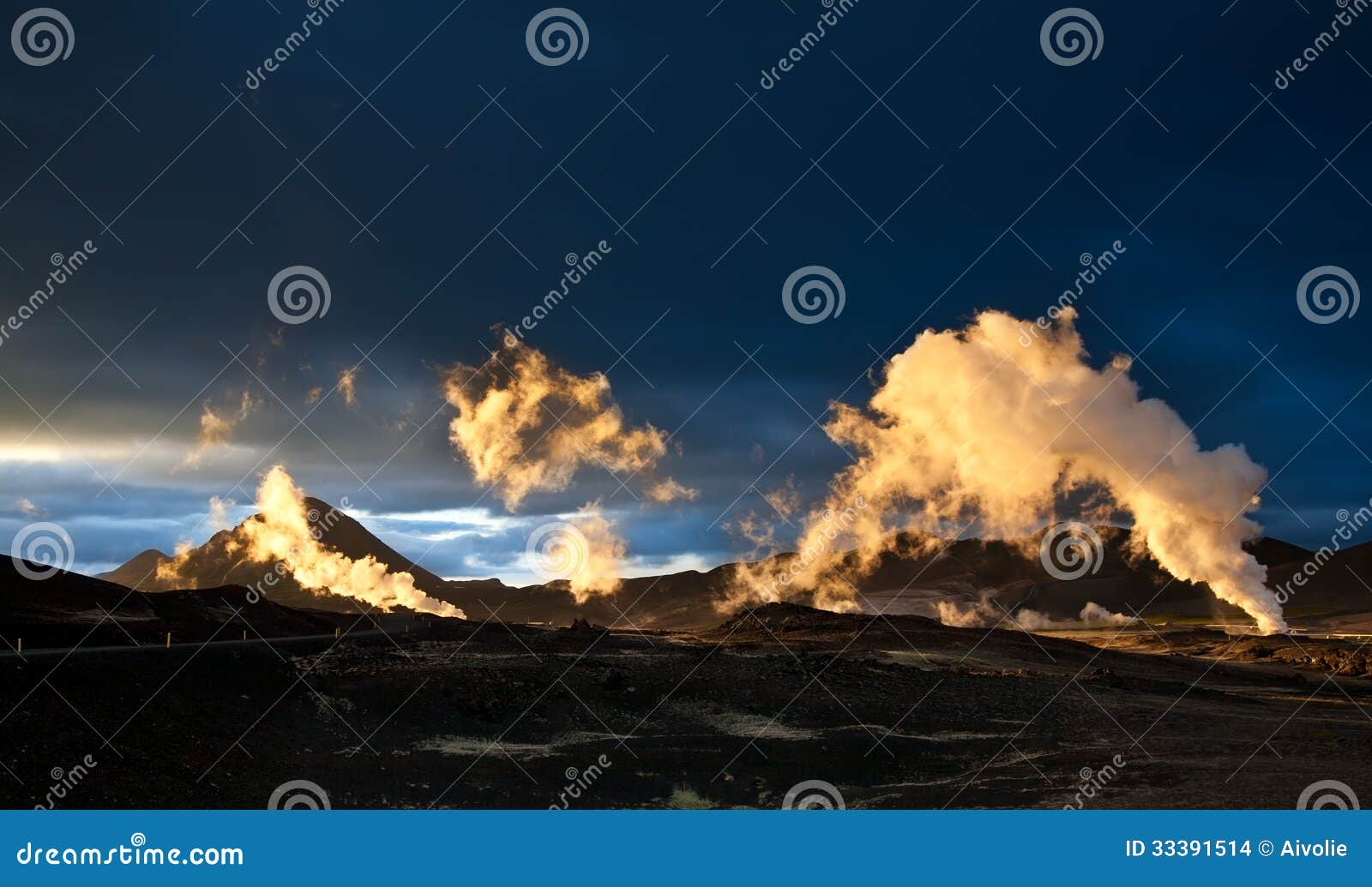 steam erupting from geothermal power station at sunset