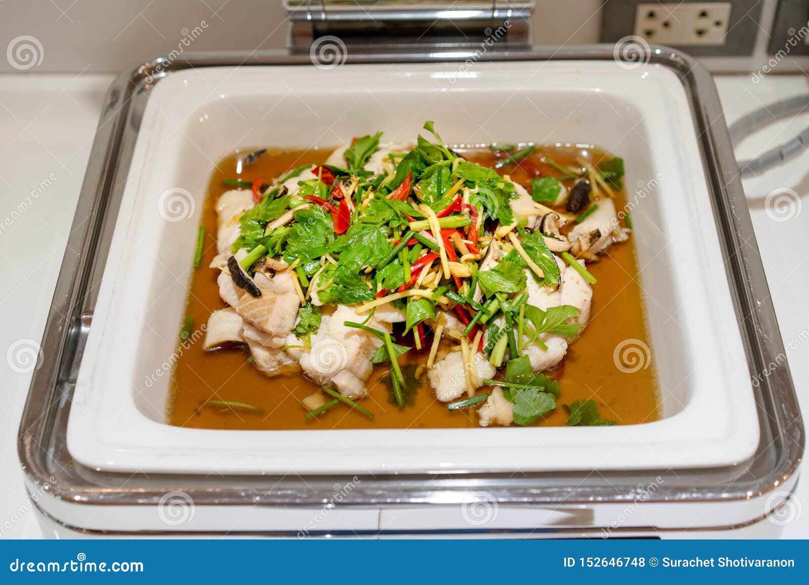 Steaming Fish in Large White Square Bowl at Thailand Resort Stock Photo