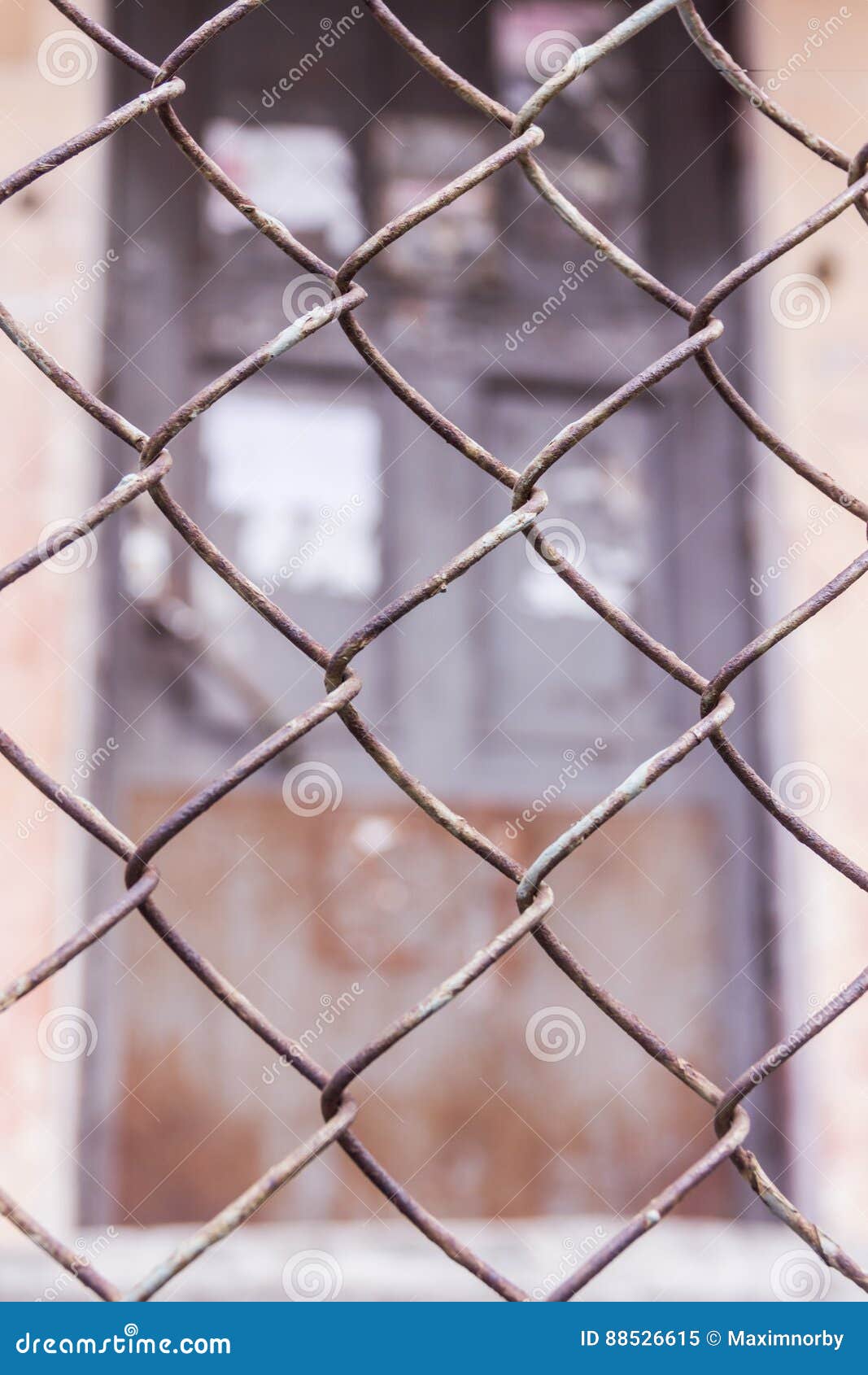 Steel Chain Link or Wire Mesh As Boundary Wall. There is Door Behind