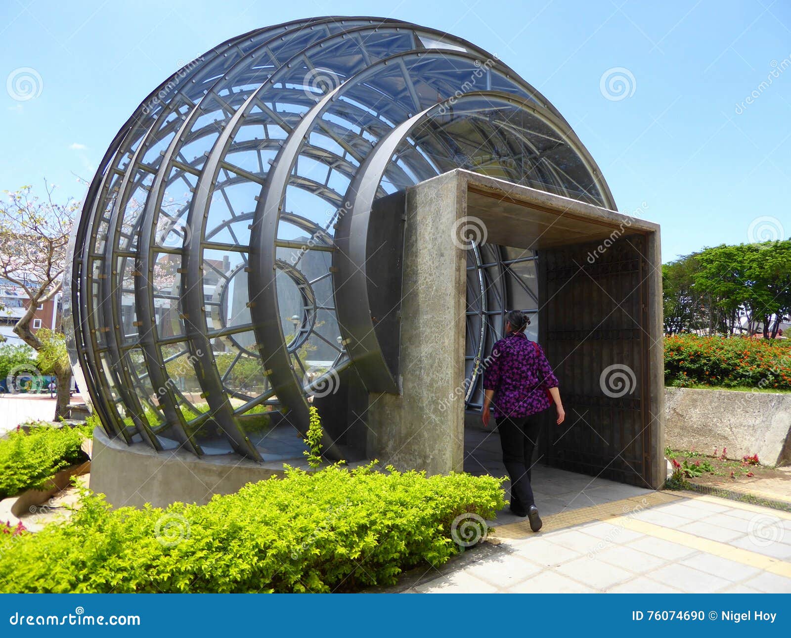 Woman Entering Circular Steel And Glass Orb Editorial Image