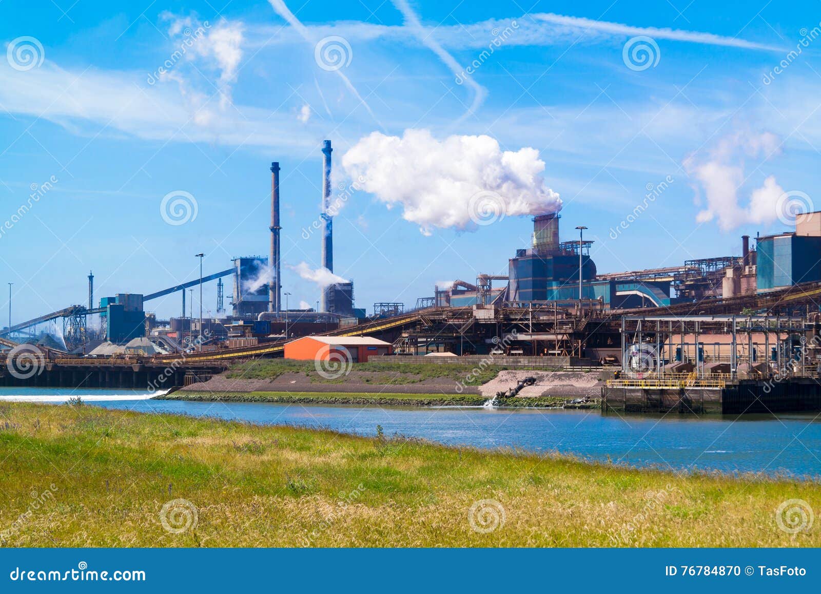 Factory Tata Steel with smoking chimneys on a sunny day, IJmuiden, The  Netherlands Stock Photo