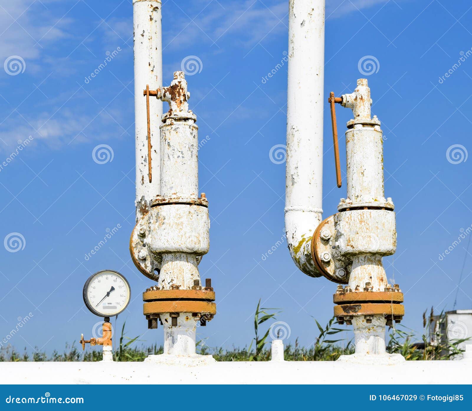 steel spring safety valve and pressure gauge on the pressure vessel. oil field equipment.