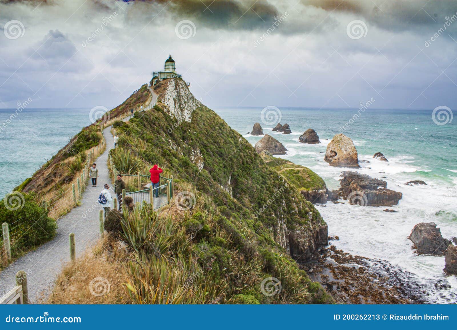 the steep headland of nugget point with nugget point lighthouse and rocky islets called the nuggets at the catlins, new zealand.