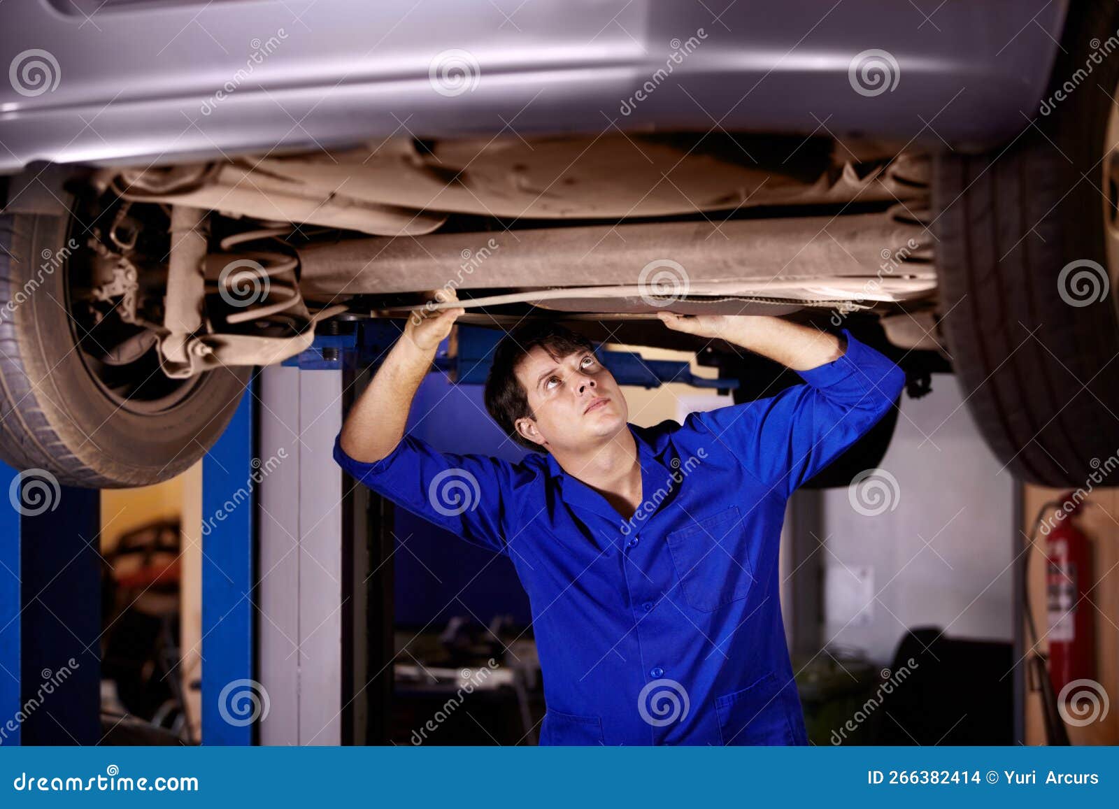 This Steering Column is a Bit Bent. a Young Male Mechanic Looking at