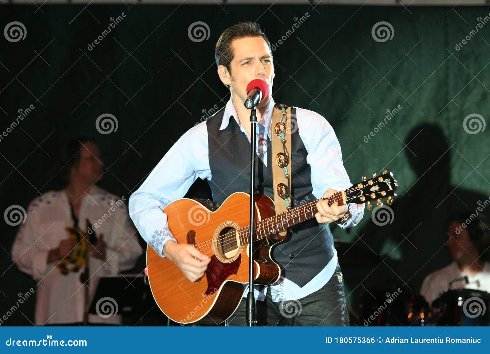 Stefan Banica Jr. Singing in Front of the Spectators on a Stage 