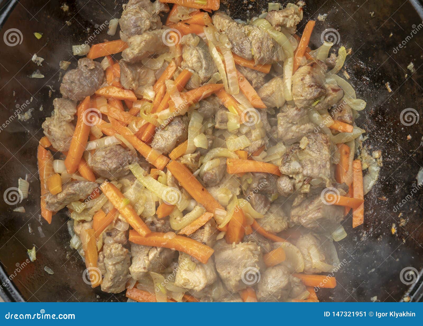 Stepbystep Process of Cooking Pilaf in a Cast Iron Cauldron Stock