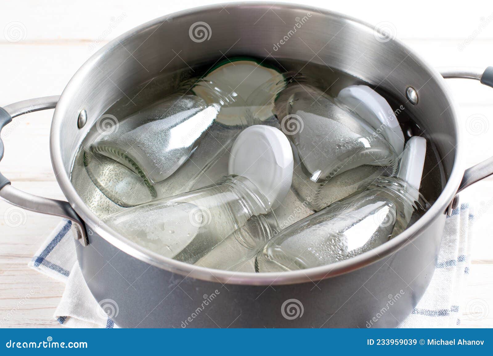 Sterilizing Glass Jars in a Steel Pan. Steaming Bubbling Wather Stock