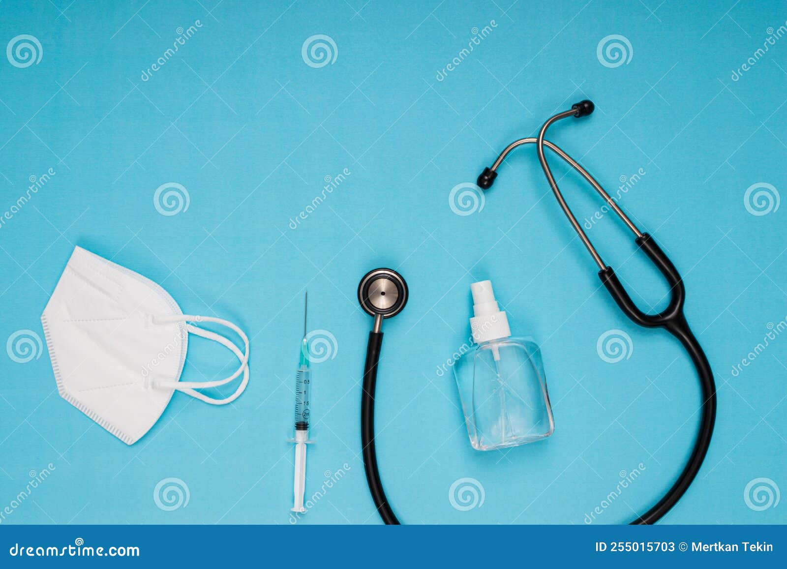 Stethoscope, Disinfectant, Needle, Vaccine, Mask Standing on Blue