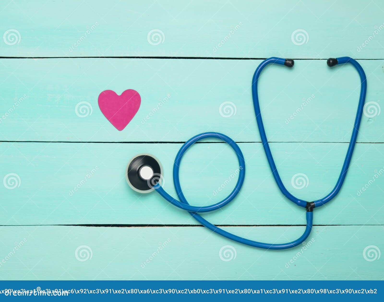 stethoscope and heart on a blue wooden table. cardiology equipment for diagnosing cardiovascular diseases. top view. flat lay.