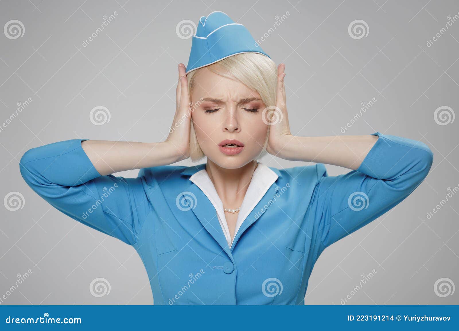 stewardess in stressful situation. fright, hysterics, phobia. gray background