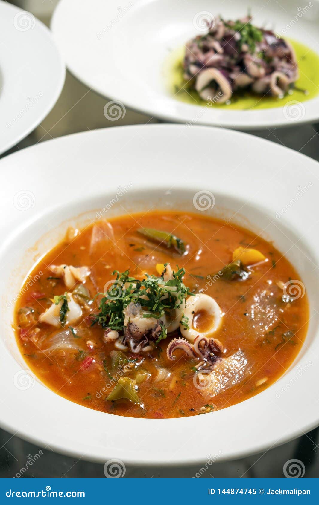 stewed squid seafood soup in spicy tomato and vegetable sauce
