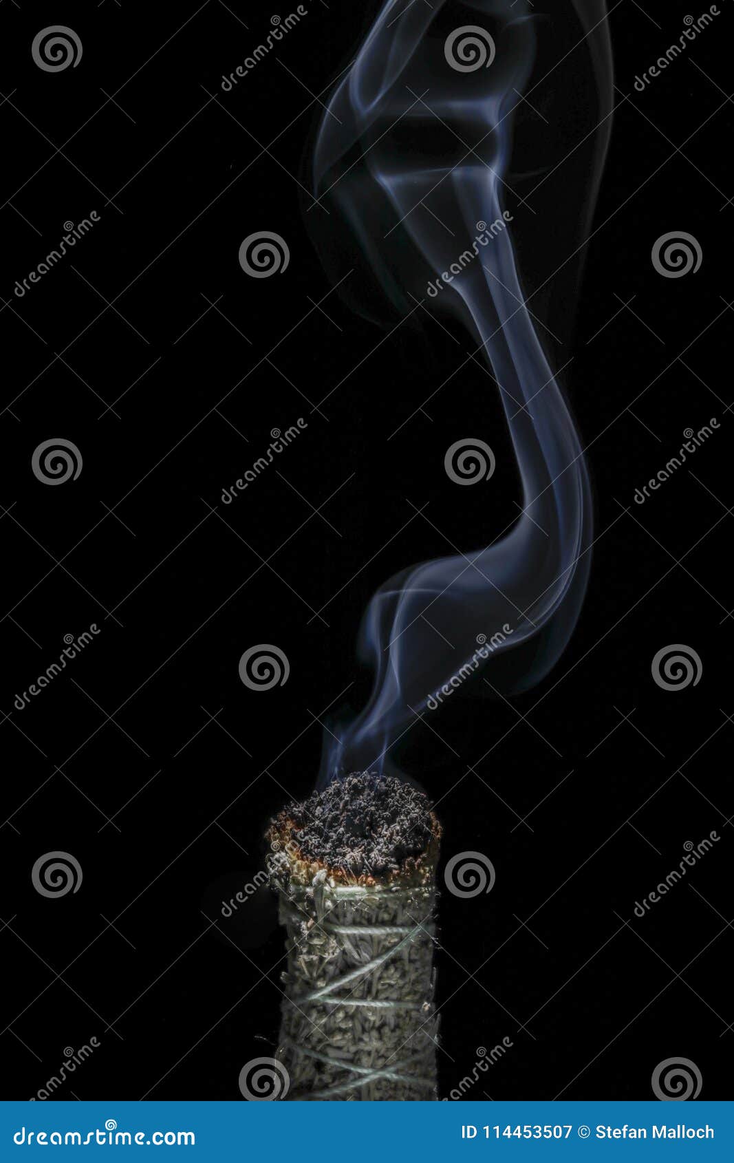 A Stick of Burning Buffalo Sage with Beautiful Flowing Smoke on a Black ...