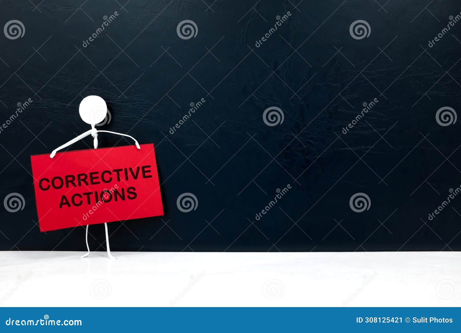 stick figure holding corrective action placard in black background. audit findings and root cause analysis