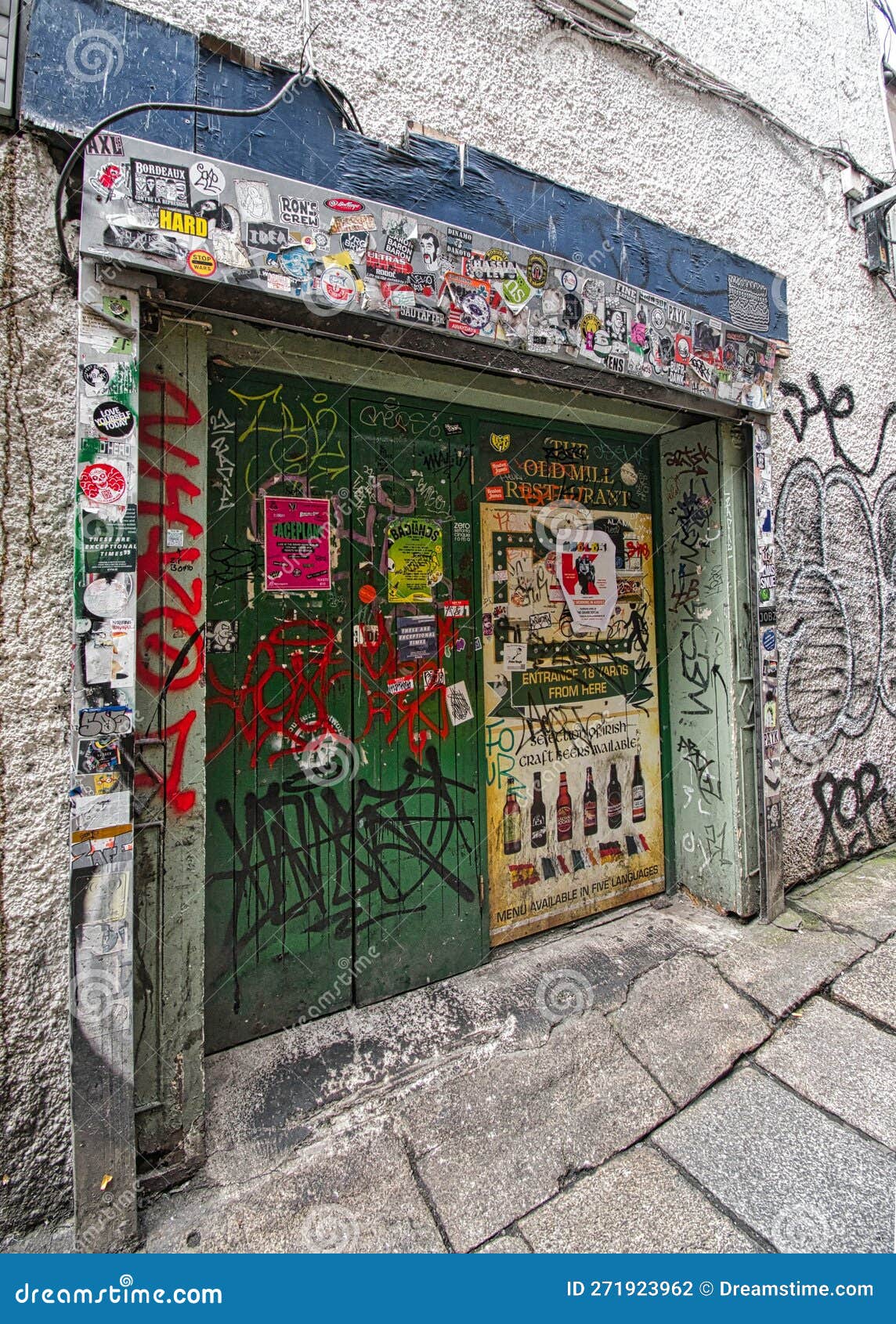 Stickers and Graffiti on a Doirway in Downtown Dublin Ireland Editorial