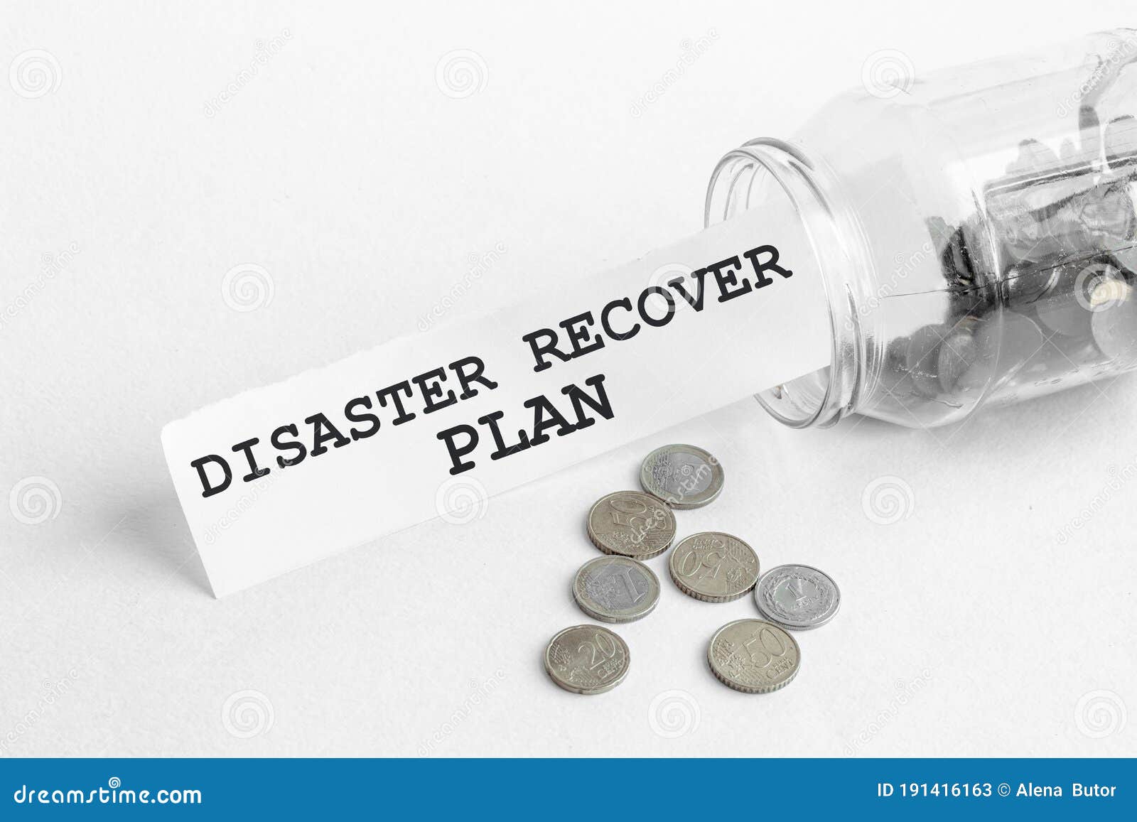 sticking out of a jar of coins a piece of paper with a text disaster recover plan on a white background