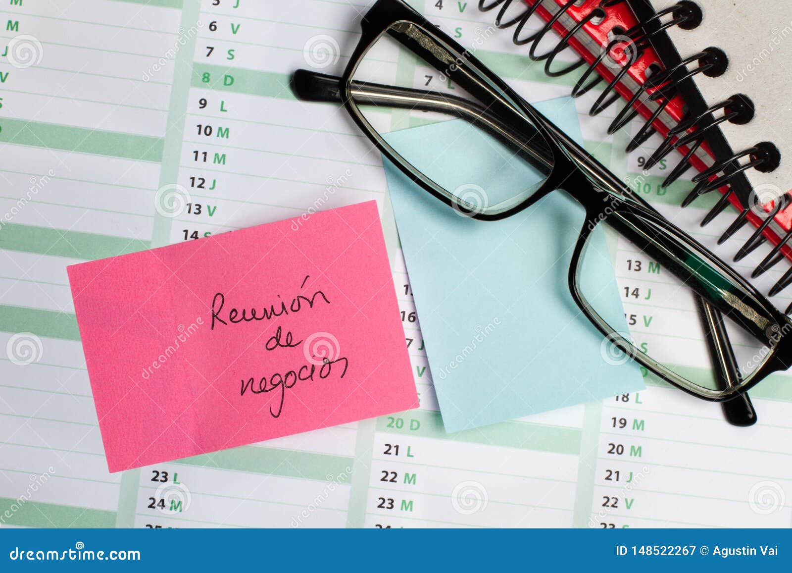 sticky note and eyeglasses on a calendar