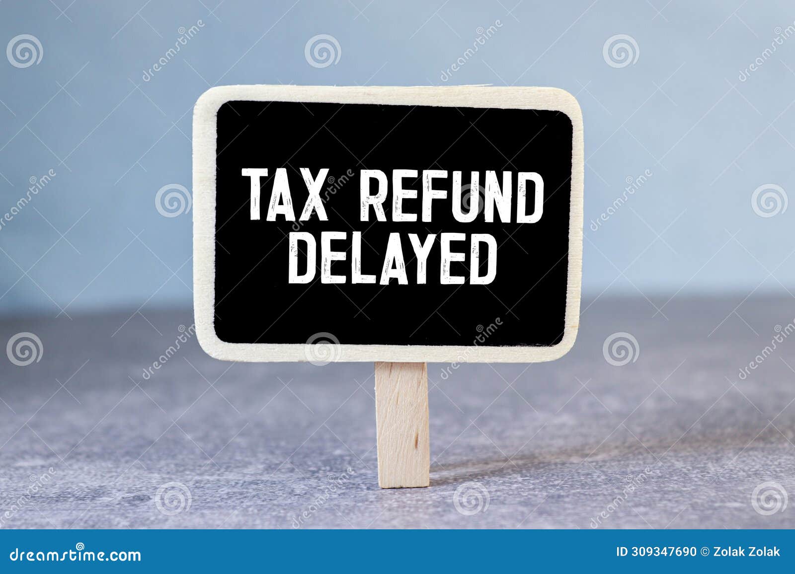 Sticky Note with the Text Tax Refund Delayed on Tax Form Background with Calculator Stock