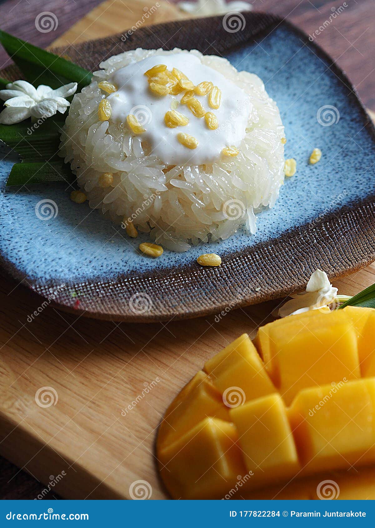 sticky rice and rip sweet mago on wood tray