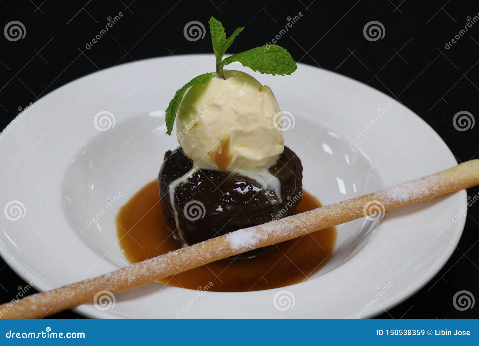 Sticky Toffee Pudding with Vanilla Ice Cream and Caramel Sauce Stock