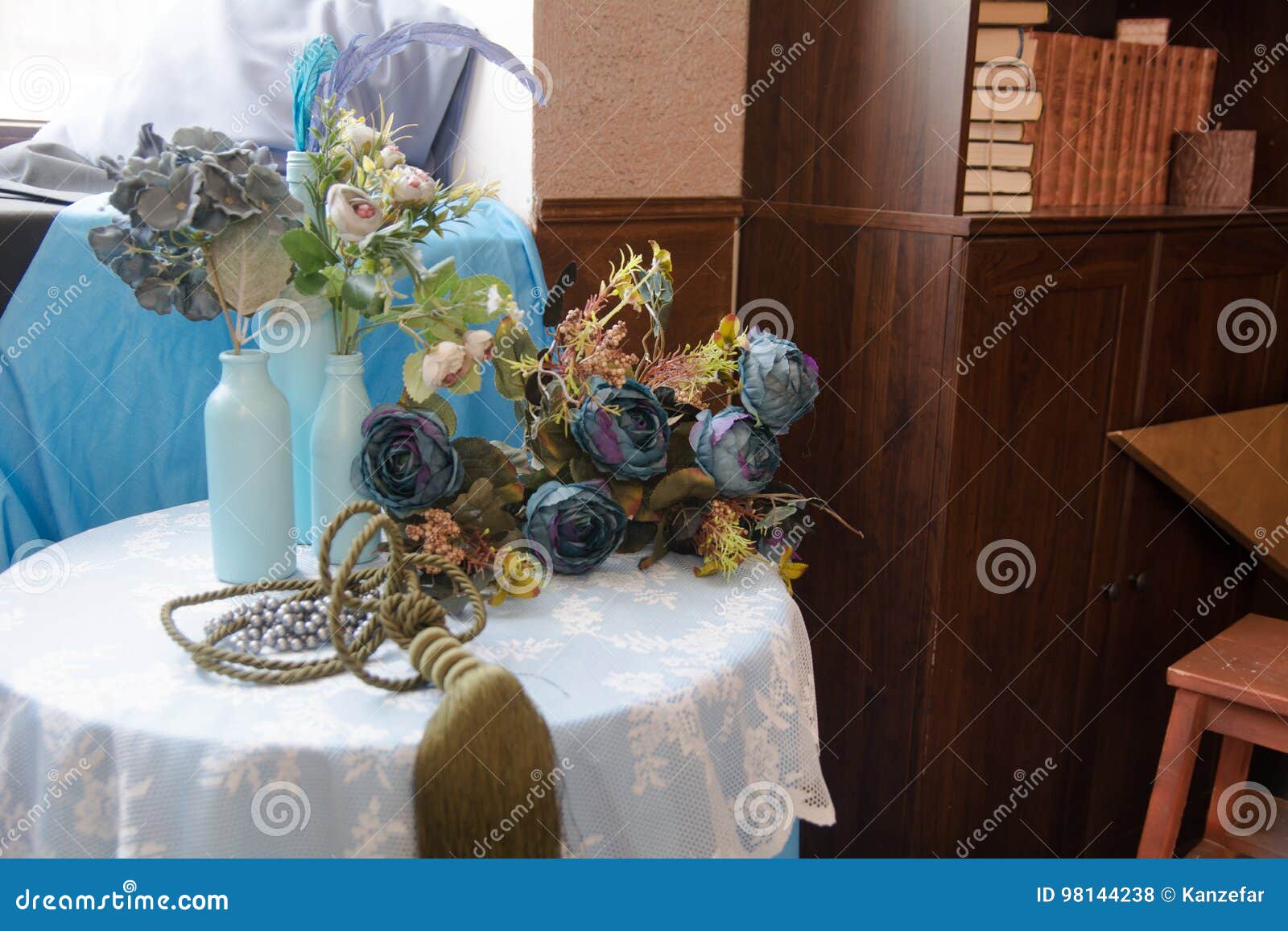 Still Life of Artificial Flowers and Glass Bottles Stock Photo Image