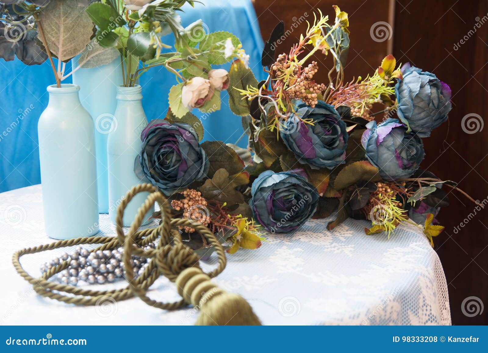 Still Life of Artificial Flowers and Glass Bottles Stock Photo Image