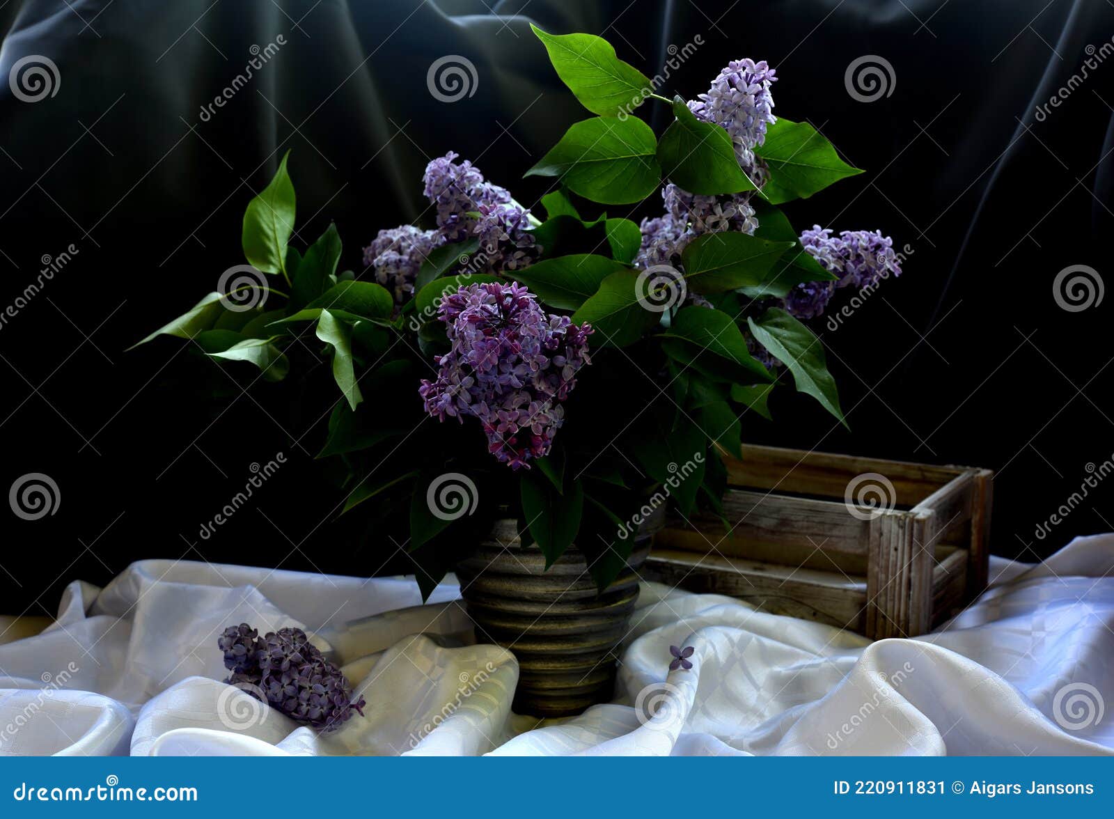 still life with branches of a colorful lilac tree in a clay vase