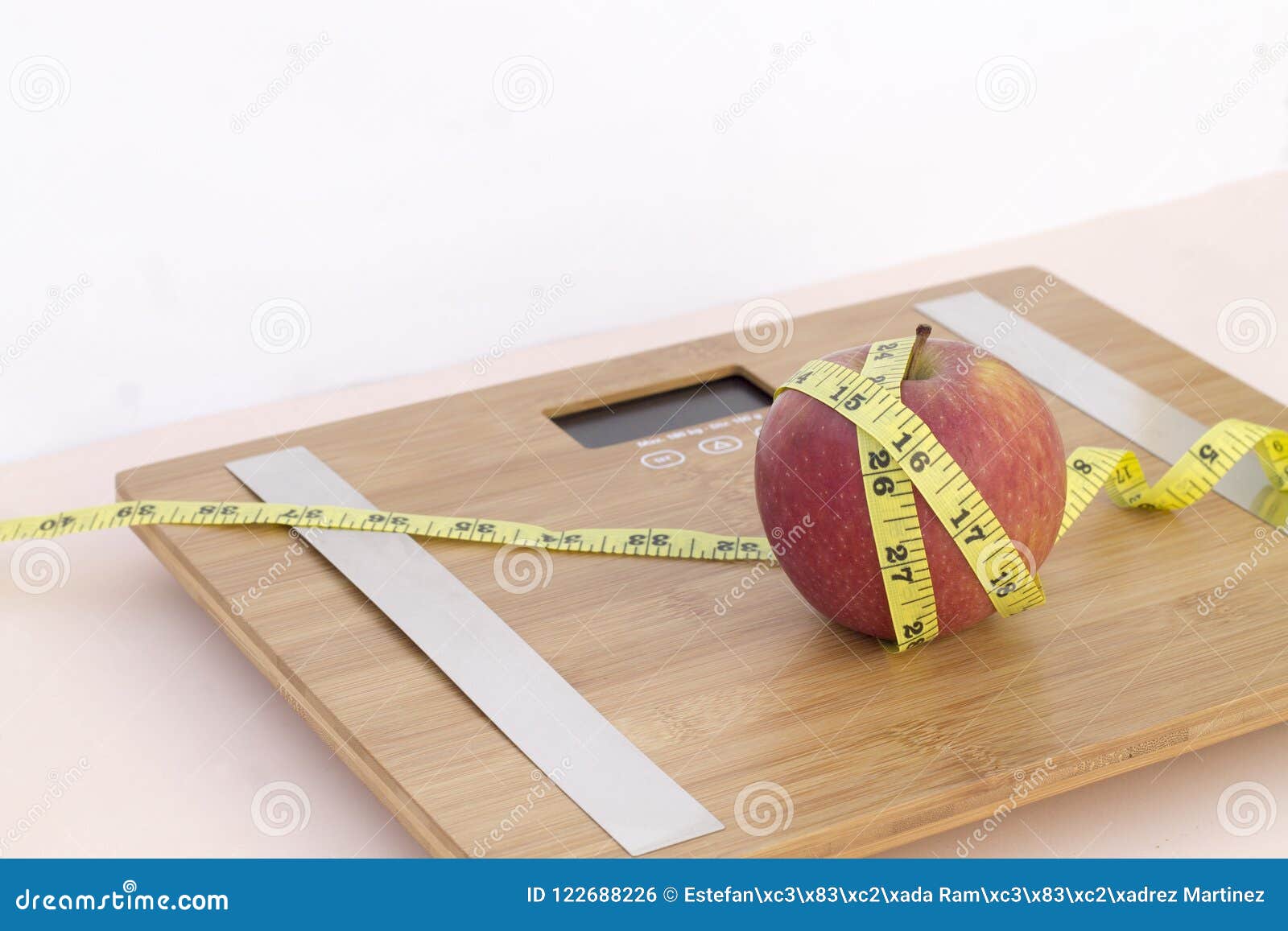still life photography with an apple, tape mesaure and a scale