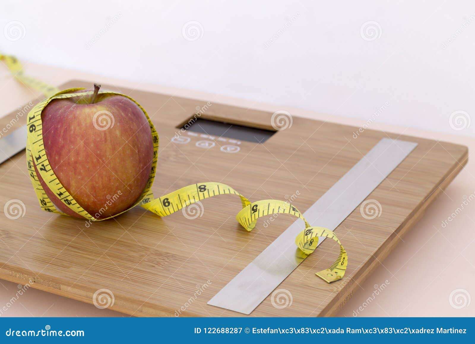 still life photography with an apple, tape mesaure and a scale