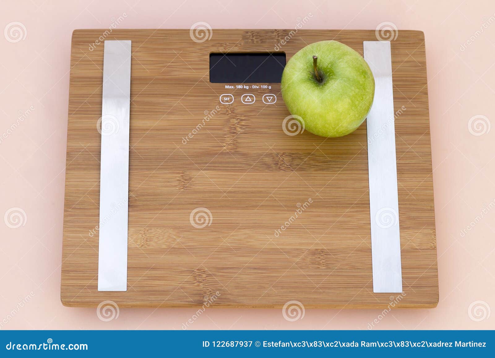 still life photography with a green apple and a scale