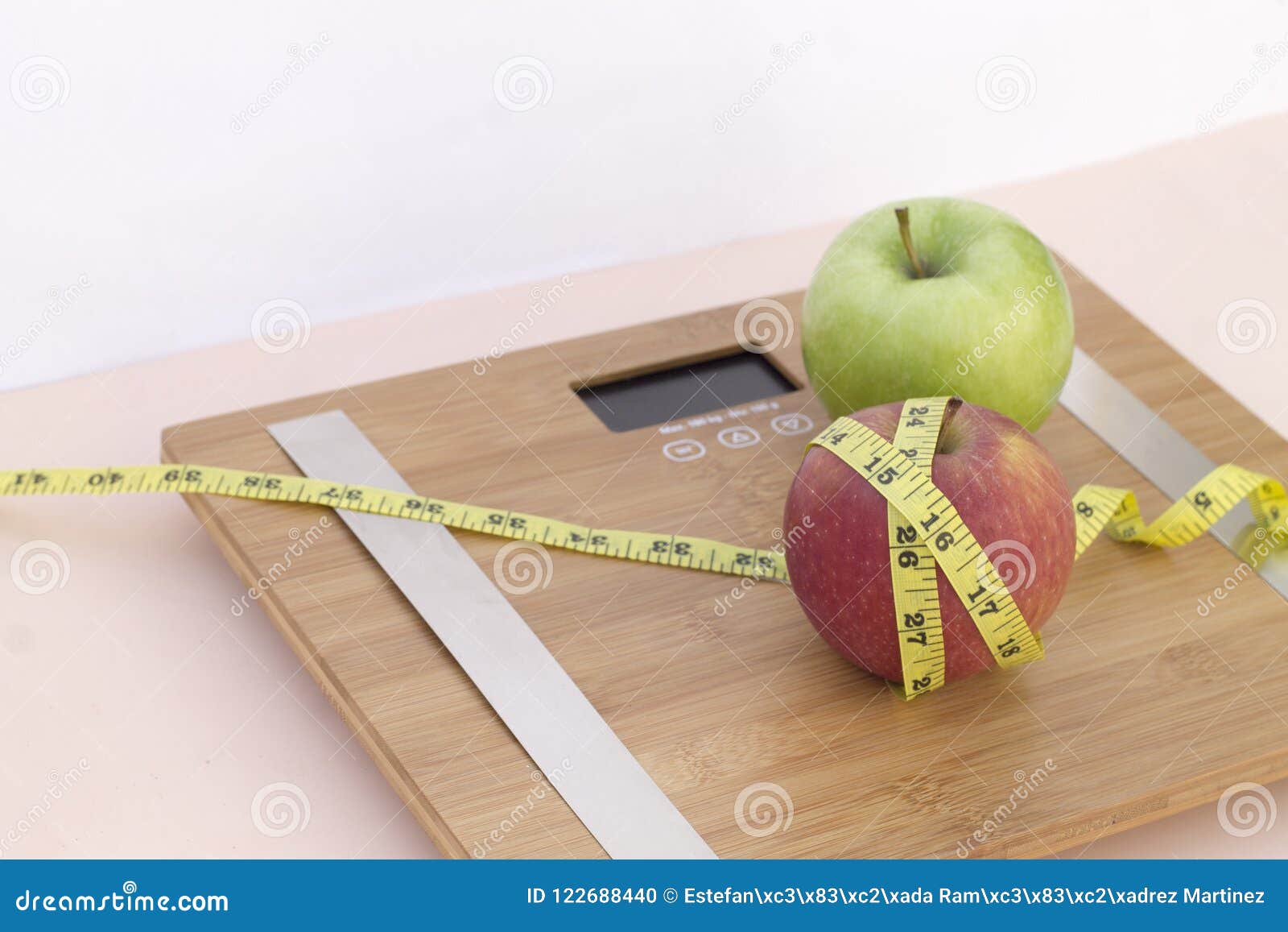 still life photography with two apples, tape mesaure and a scale