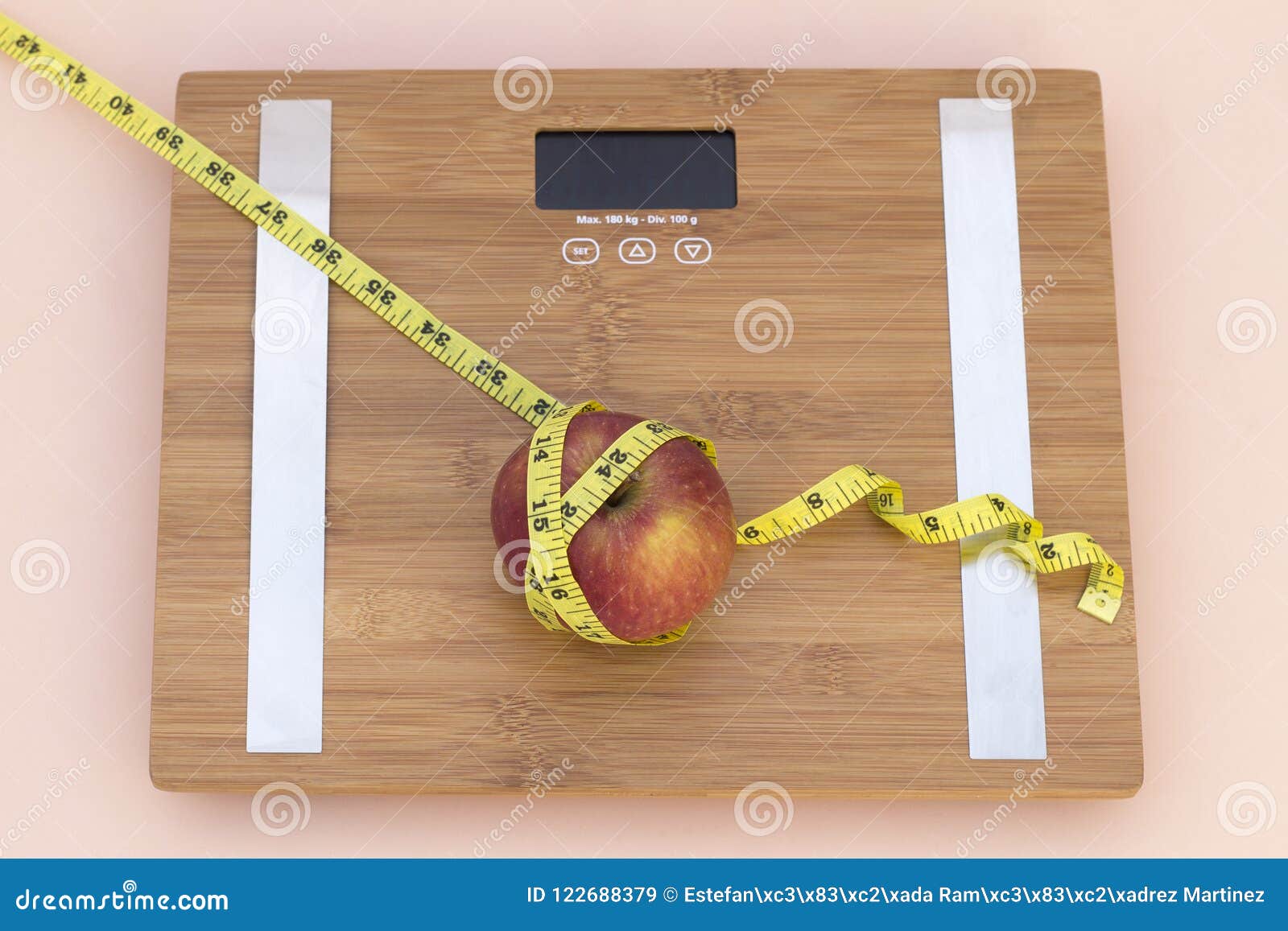 still life photography with an apple, tape mesaure and a scale