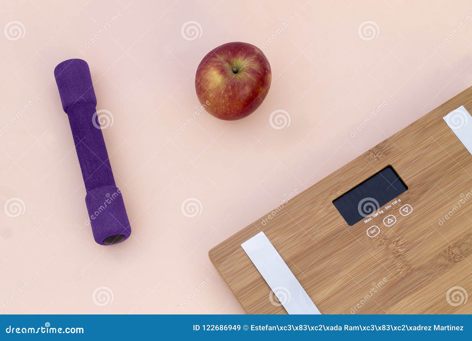 still life photography with a red apple, weight and a scale
