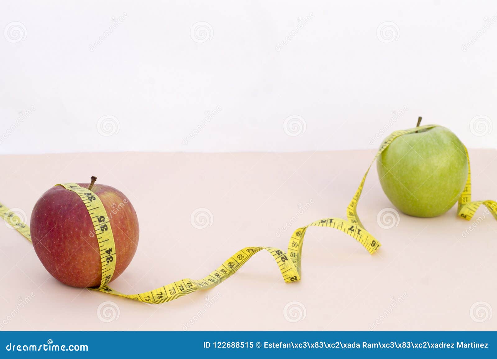 still life photography with two apples, tape mesaure