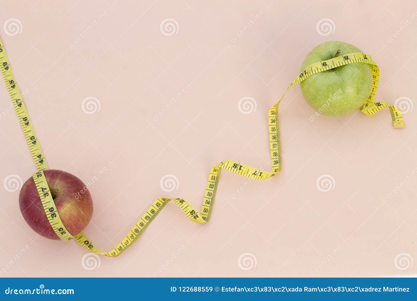 still life photography with two apples, tape mesaure