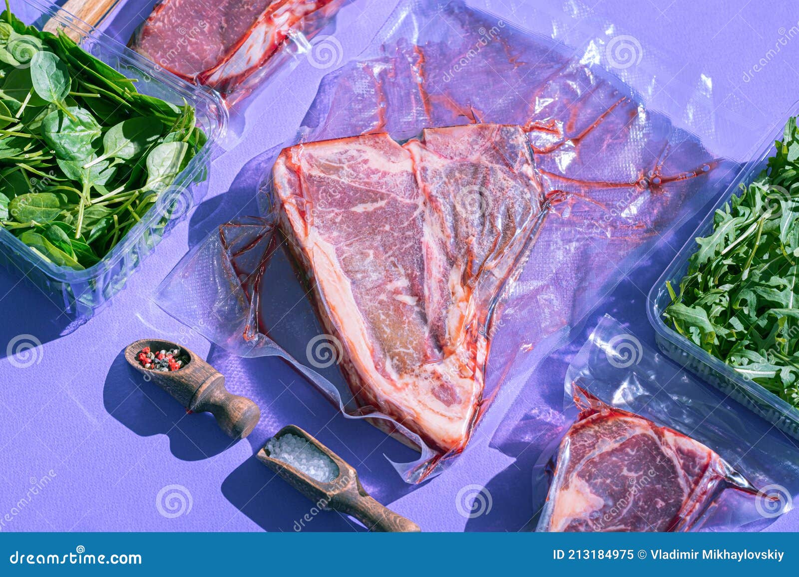 Still Life of Vacuumpacked Meat with Herbs and Butcher`s Tools Stock