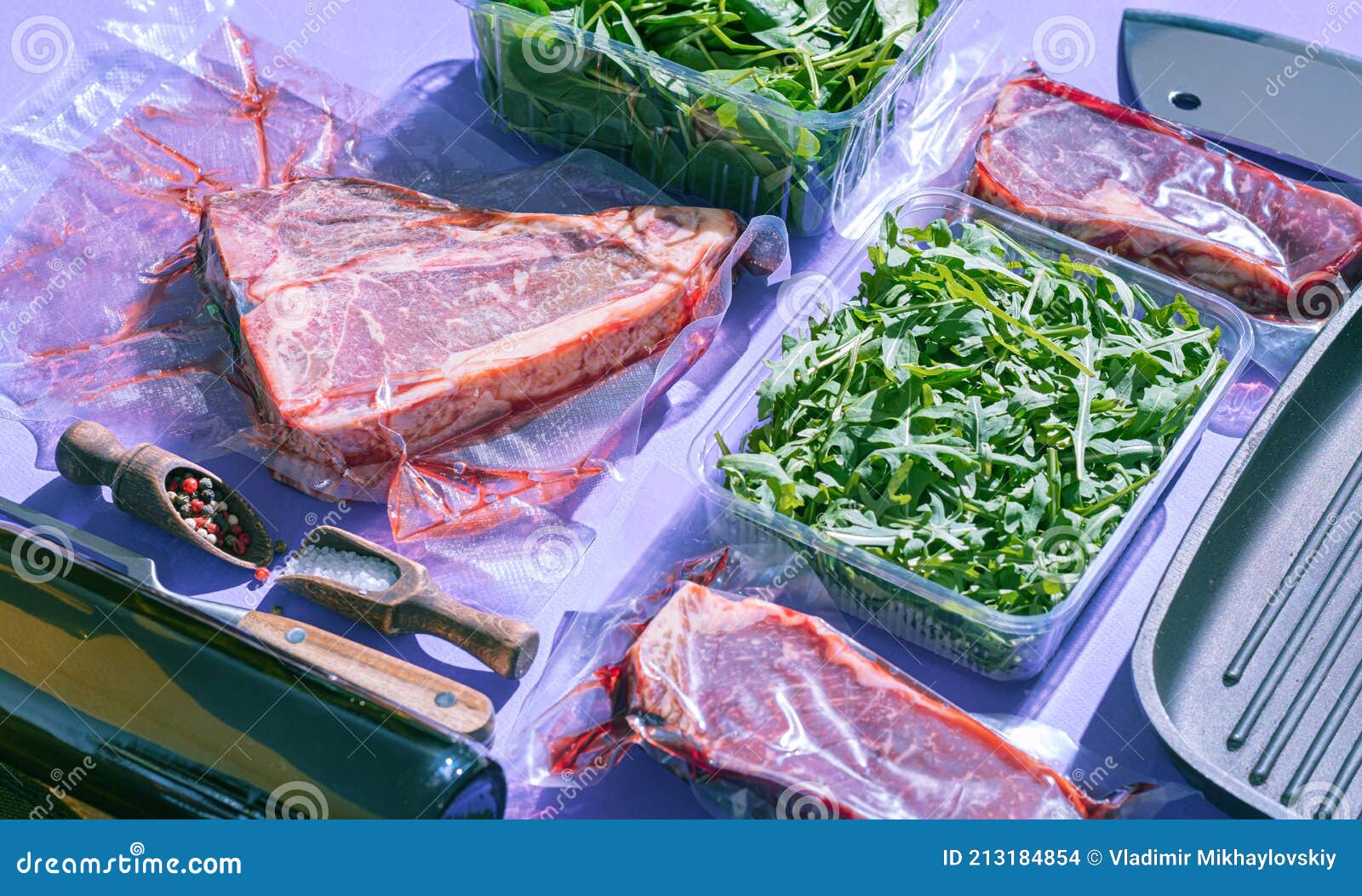 Still Life of Vacuumpacked Meat with Herbs and Butcher`s Tools Stock