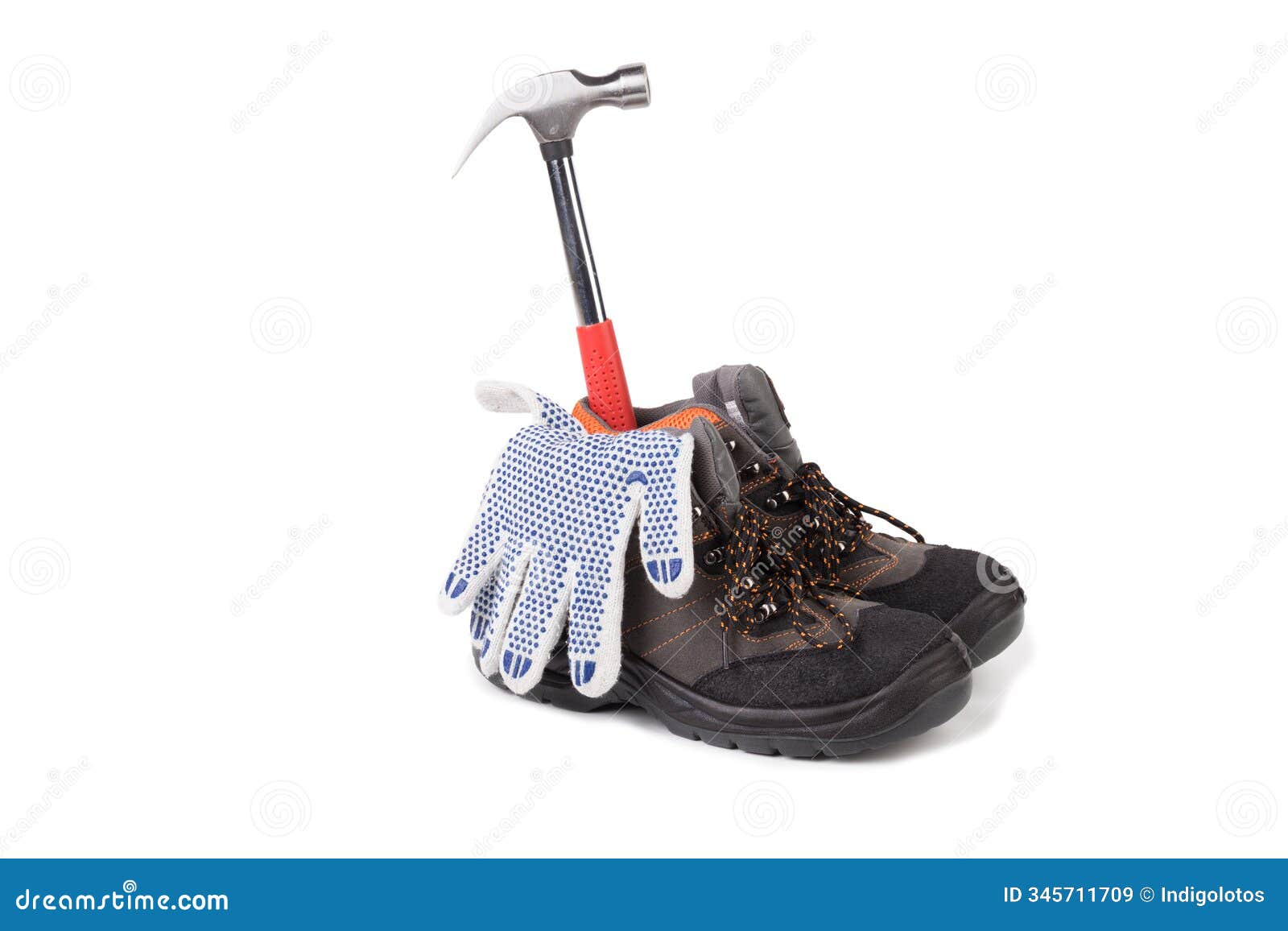 a still life of work boots, a hammer and protective gloves