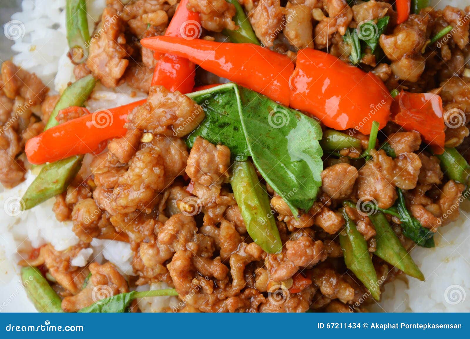 Stirfried Minced Pork with Chilli and Basil Leaves on Rice Stock Photo