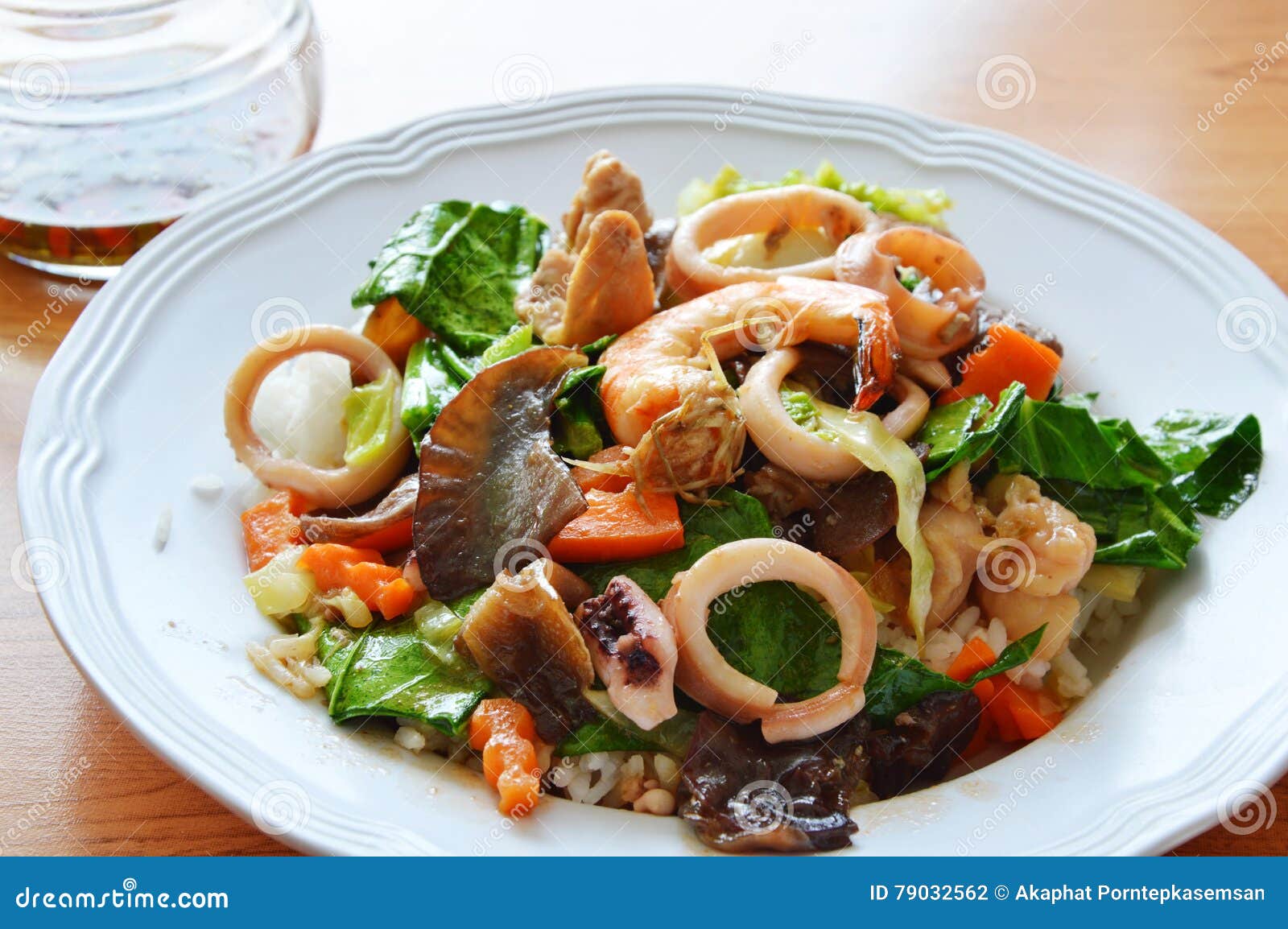 Stir Fried Mixed Vegetable with Seafood and Pork on Rice Stock Photo