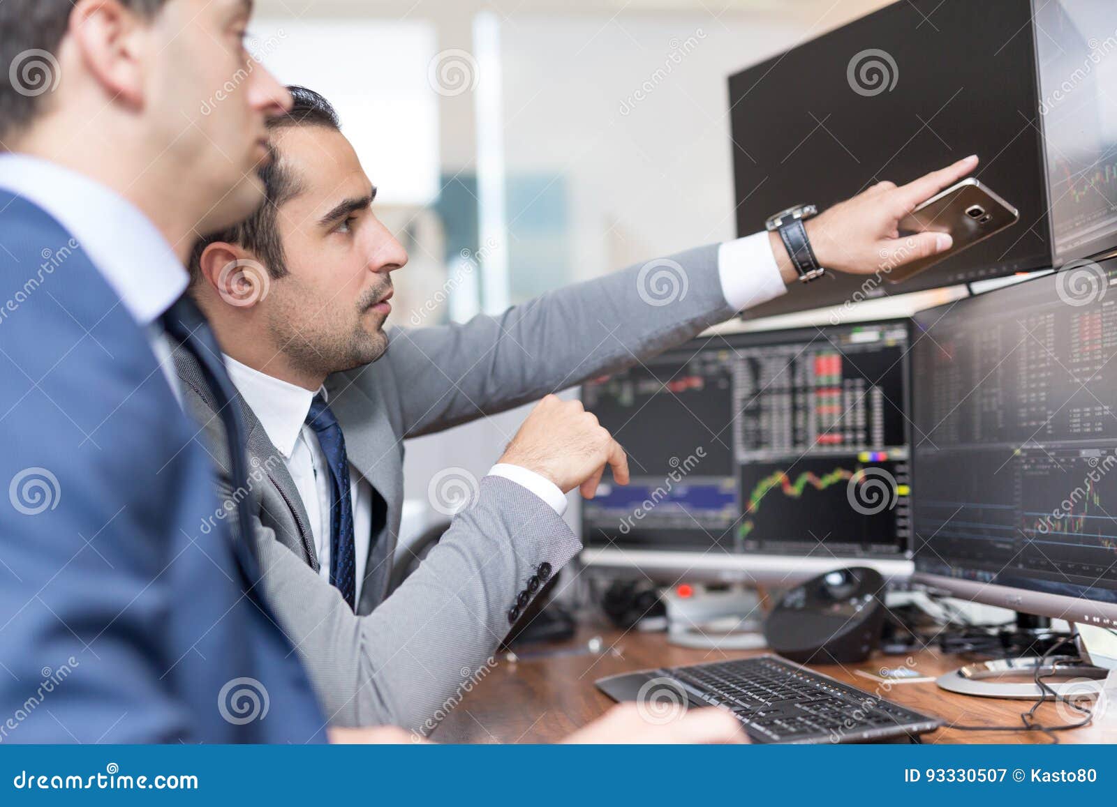 stock brokers looking at computer screens trading online stock stock brokers